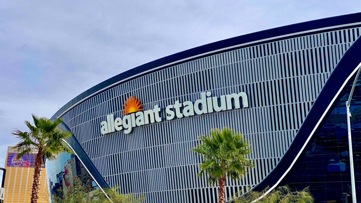 Allegiant Stadium in Las Vegas, home of the Raiders, with palm trees in front