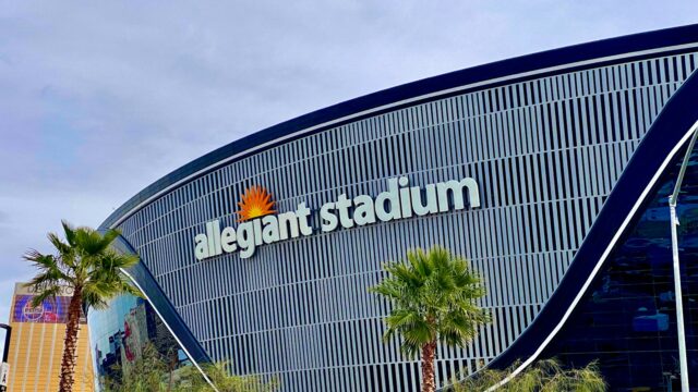 Allegiant Stadium in Las Vegas, home of the Raiders, with palm trees in front